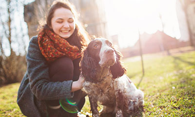 Woman walking in the park with dog